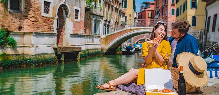 Venice, Italy Couple enjoying a romantic picnic along a canal in Venice, Italy