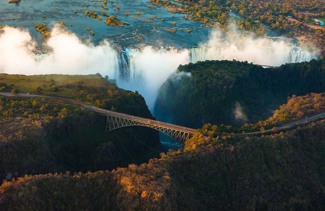 Aerial view of Victoria Falls: feel the misty spray and hear the roaring cascades of the 'Smoke That Thunders.