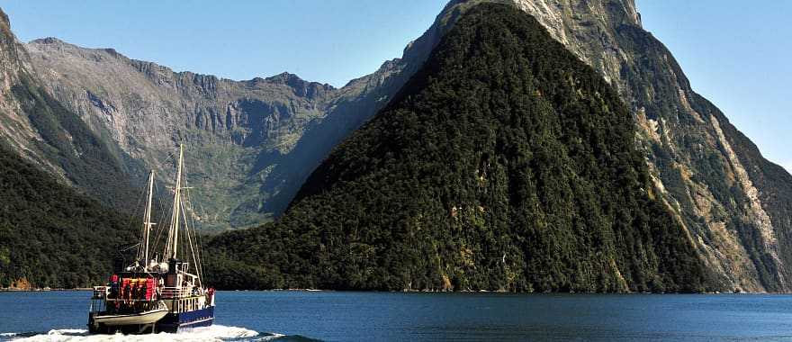 Ship under Mitra Peak in Fiordland National Park on South Island, New Zealand