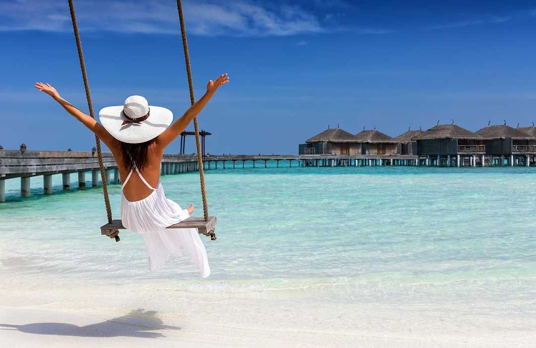Woman enjoying a seaside swing in the Maldives
