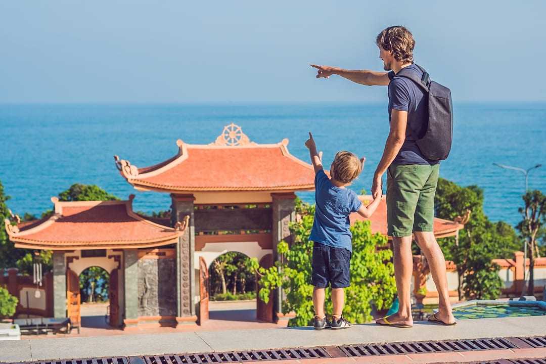 Family at Ho Quoc Pagoda entrance doors, Phu Quoc, Vietnam