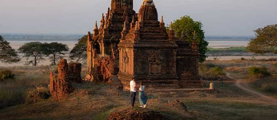 Couple enjoying view of a buddhist temple in Myanmar