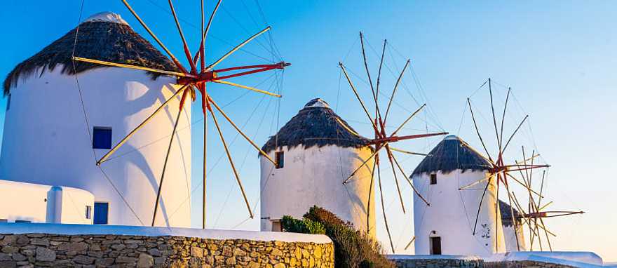 Mykonos, Greece Famous windmills of Mykonos town at romantic sunset, Greece