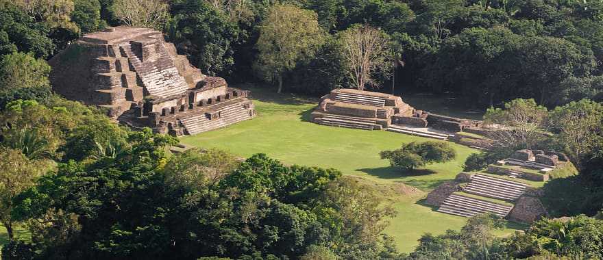 Mayan temples rise above the treetops like ancient skyscrapers.