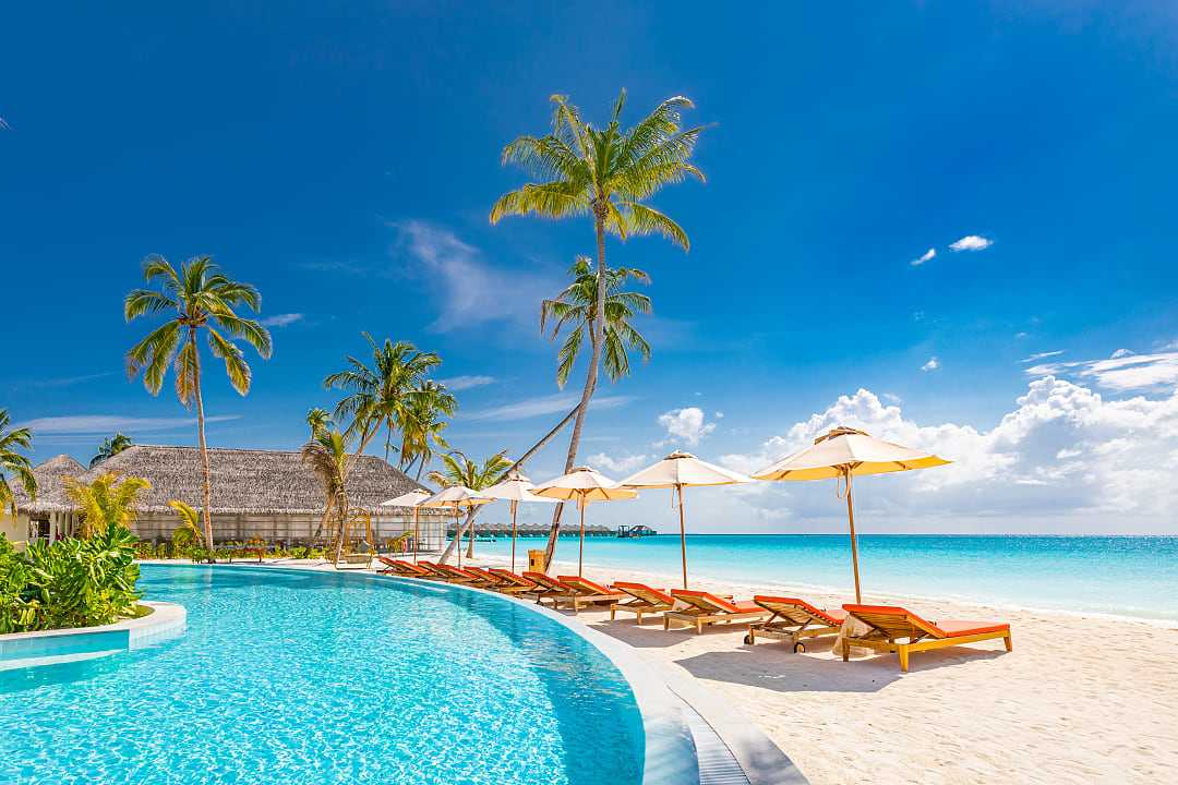 Luxury resort pool by the beach in the Maldives