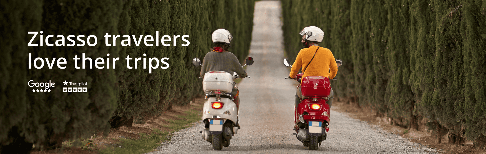 A couple on scooters on a tree-lined street in Tuscany