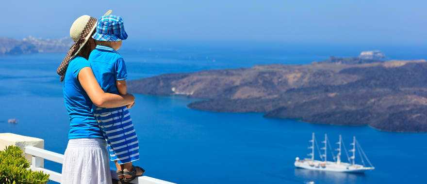 Mother and son looking out over the water in Santorini, Greece