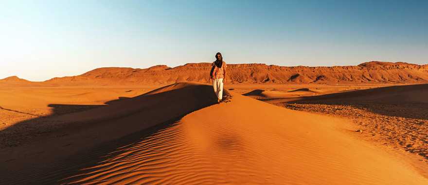 Morocco Tour for Solo Travelers: Discovery, Culture & Cooking Course Solo traveler on sand dunes in Morocco
