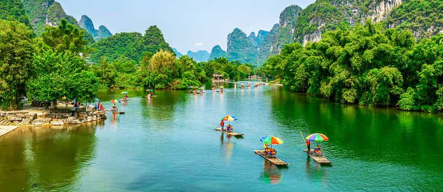Guilin, China Tourists on bamboo boats floating down the Li River between the karsts in Guilin, China