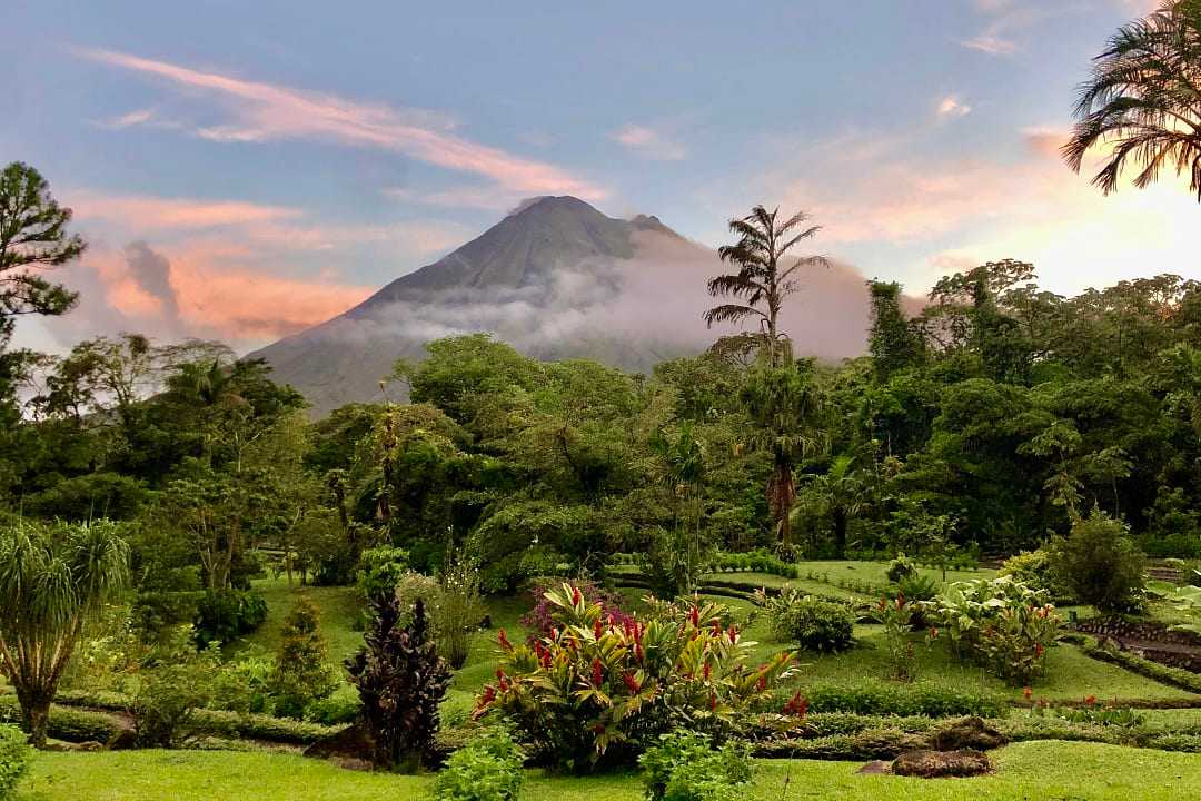 Arenal Volcano in Costa Rica, surrounded by lush rainforest.