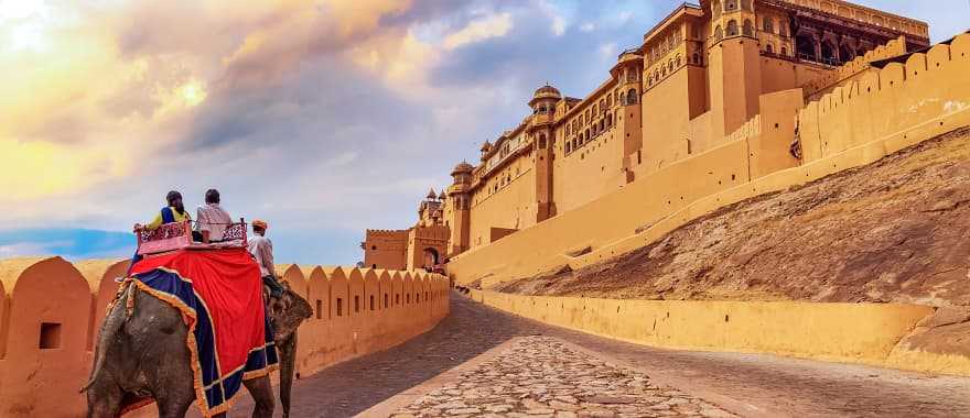 Senior tourists enjoy elephant ride at Amer Fort in Jaipur, India