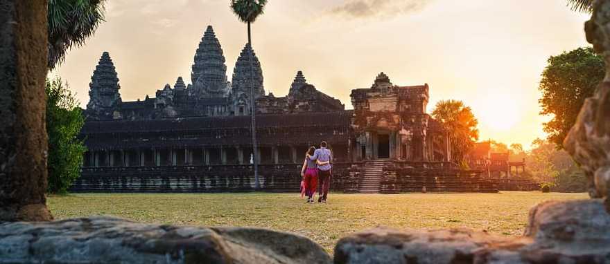 Couple walking thru Angkor Wat in Siem Reap, Cambodia Couple walking thru Angkor Wat in Siem Reap, Cambodia