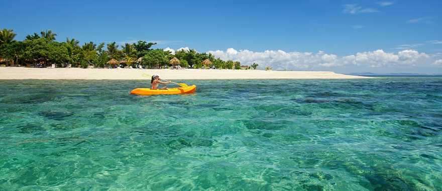 Mamanuca Islands, Fiji Woman kayaking in the Mamanuca Islands, Fiji