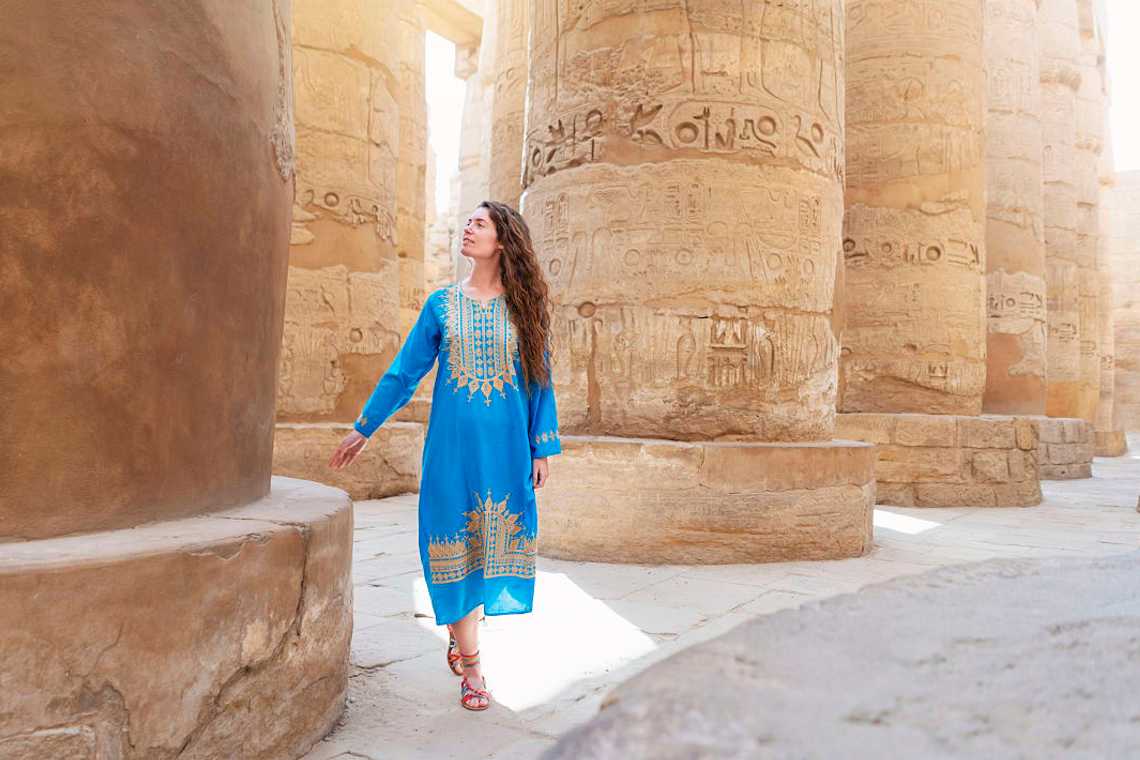 Woman marveling at hieroglyphics in Luxor, Egypt