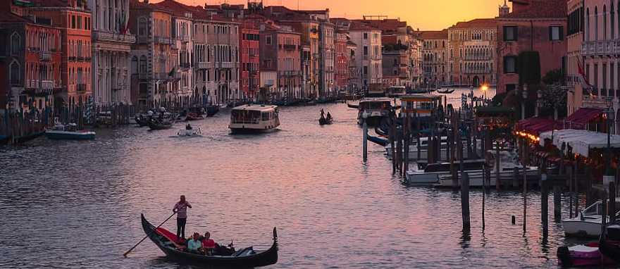 Grand Canal in Venice, Italy Couple taking sunset gondola ride on the Grand Canal in Venice, Italy