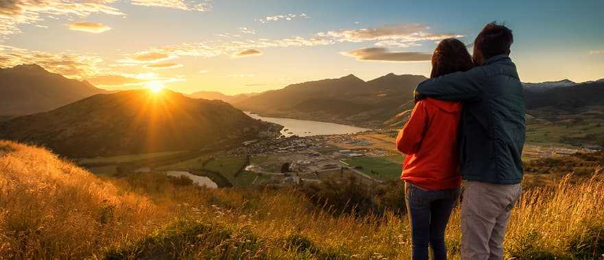 Couple enjoying a sunset in New Zealand 