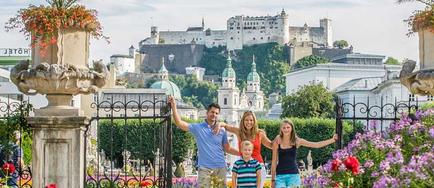 Family in Salzburg, Austria. Photo courtesy of Tourismus Salzburg Family on vacation in Salzburg, Austria posing with Hohensalzburg in the background