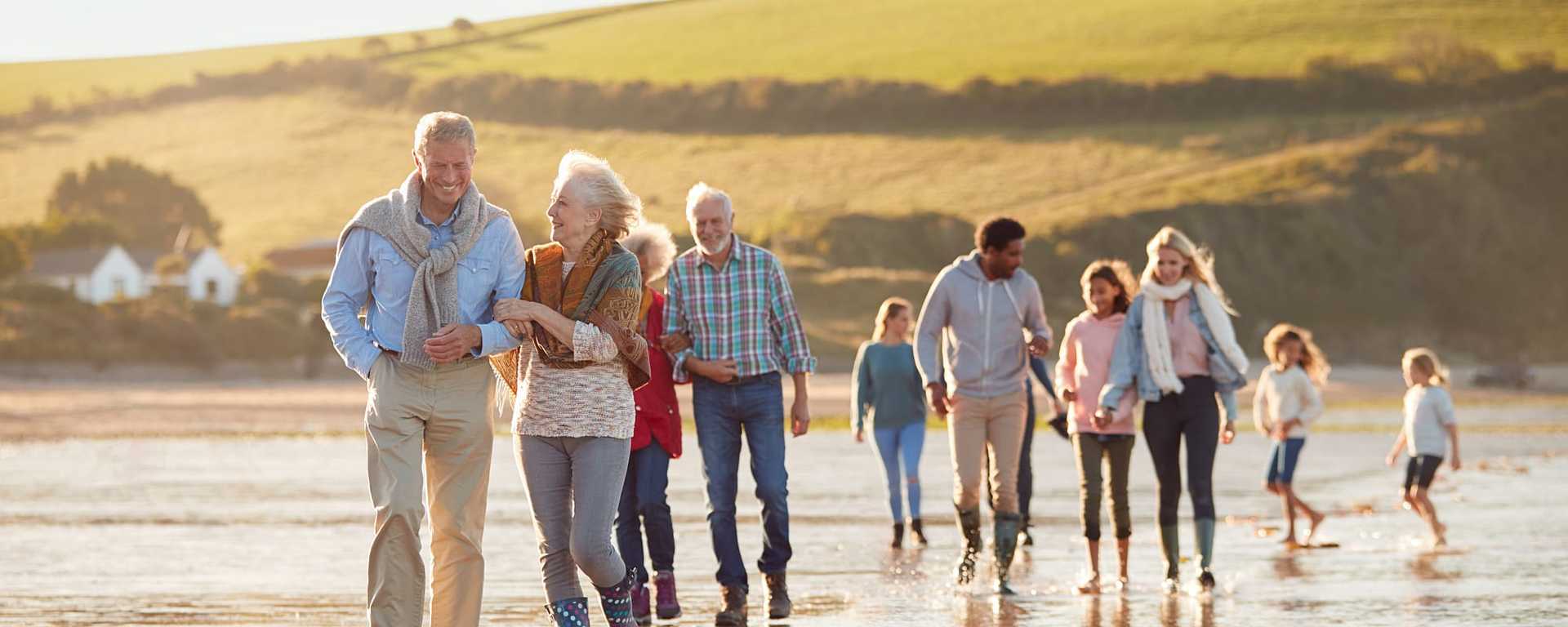 Multi-generational family walking on the beach while on vacation in Wales