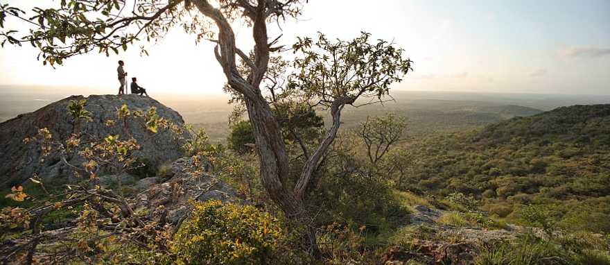 Phinda Private Reserve, South Africa. Photo courtesy andBeyond Couple viewing the vast landscape of Phinda Private Game Reserve at sunset in South Africa