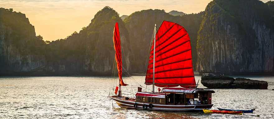 Ha Long Bay, Vietnam A red junk boat sailing in Ha Long Bay in Vietnam.