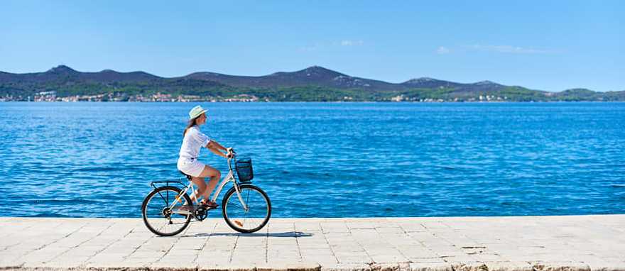 Woman cycling in Croatia Woman cycling in Croatia