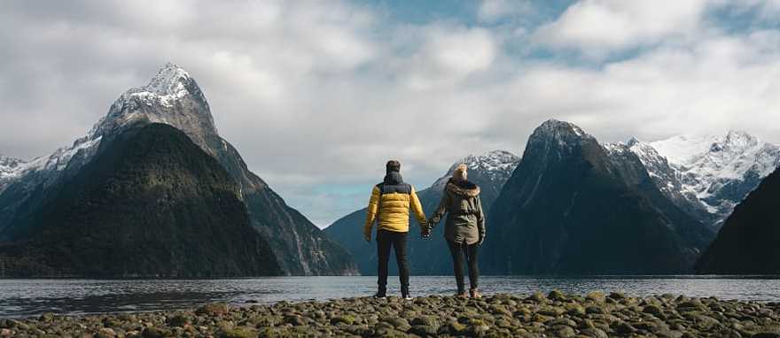 Couple at Milford Sound in New Zealand Couple at Milford Sound in New Zealand