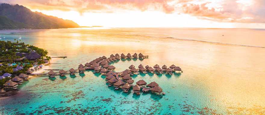 Overwater bungalows along coral reef in Moorea, French Polynesia