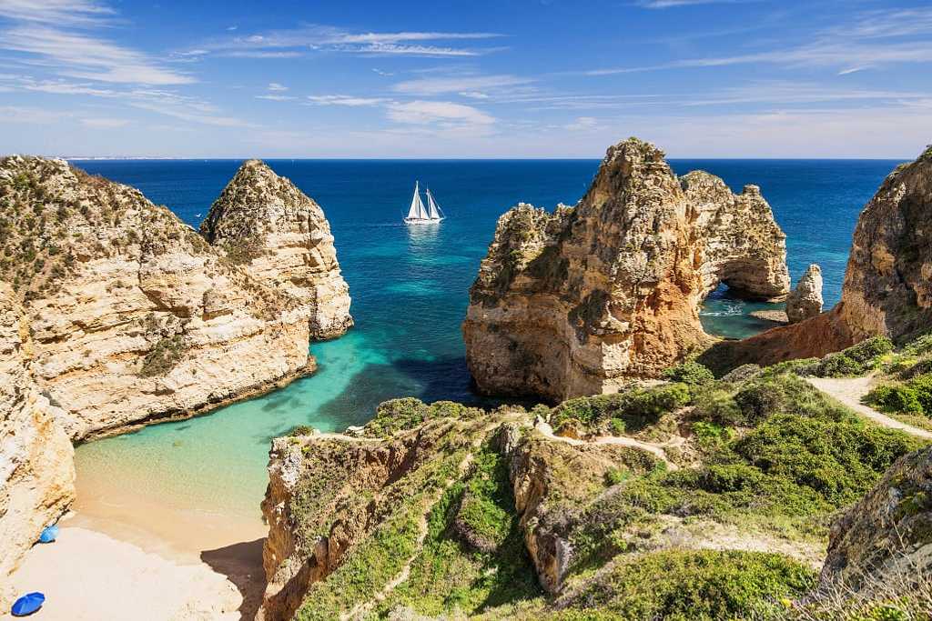 Sailing the beautiful blue bay near Lagos, in the Algarve region in Portugal