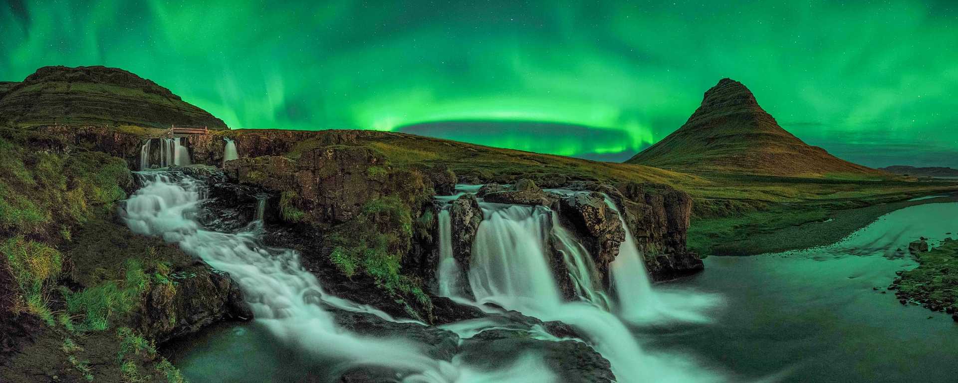 Northern lights over Kirkjufell and Kirkjufellsfoss in Iceland