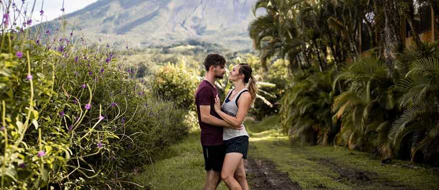 Couple with the Arenal volcano in the background in Costa Rica Couple with the Arenal volcano in the background in Costa Rica