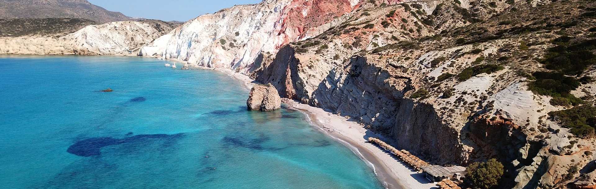 Clear summer day at Volcanic white chalk iconic beach of Firiplaka on Milos island, Greece