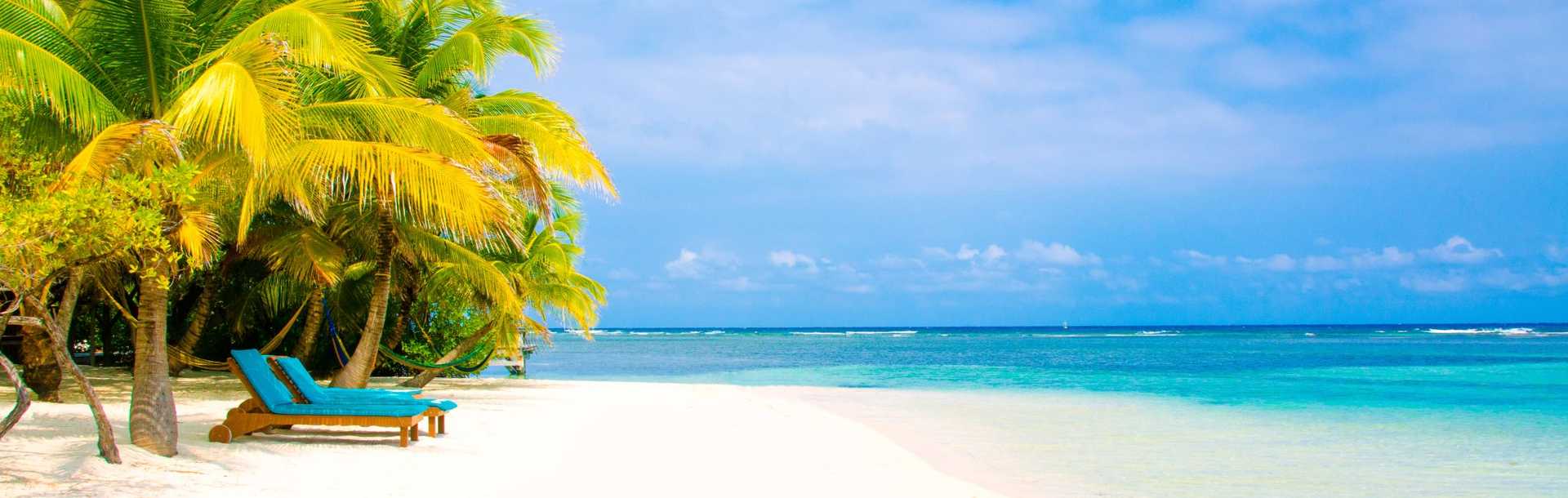 Two lounge chairs on the beach in Belize